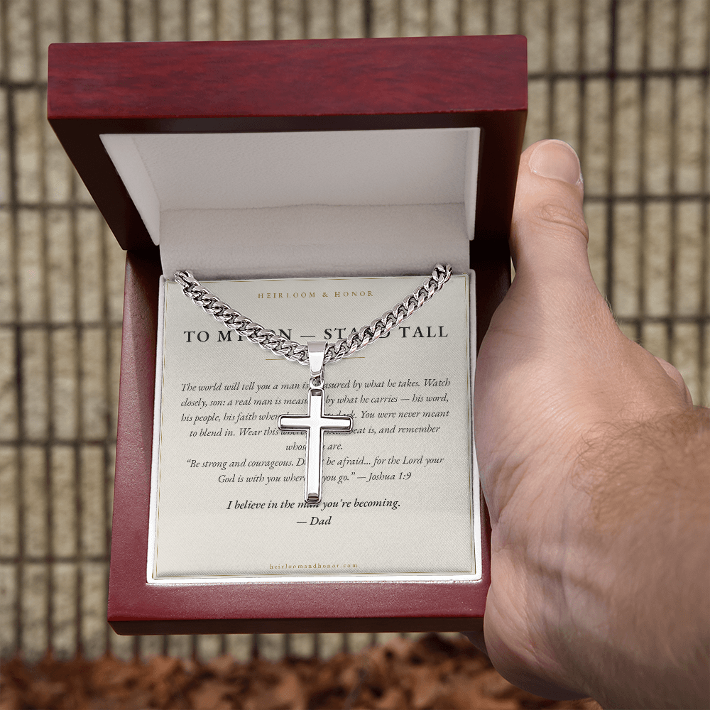 Hand holding mahogany gift box with To My Son cross necklace and message card